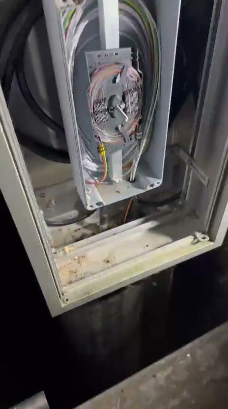 Freigelegtes Glasfaserkabel in der Baugrube während der Reparatur